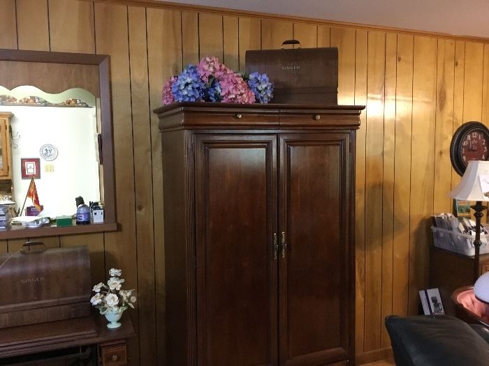 Armoire - vintage sewing machine in case on top