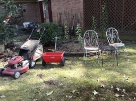 Lawn mower (works), spreader, great metal chairs & a table - more tools in background