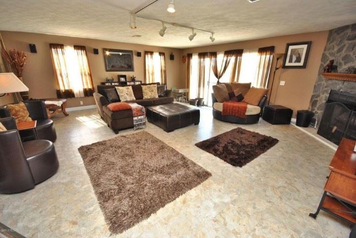 Huge living room full of modern furniture & decor.