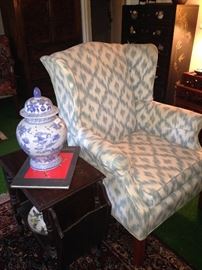 Wingback chair, ginger jar, and side table