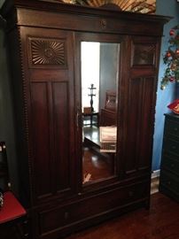 A stunning mirrored antique armoire