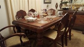 Antique table with 6 chairs. (2 arm chairs) plus matching buffet availablei