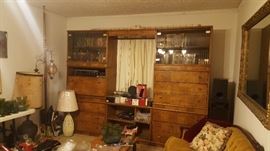 Wooden entertainment center full of VHS & CD's.  Children, westerns, war, action, old comedy.  Some collector sets. Entertainment center  has 8 separate pieces for easy moving and pieces can be separated to make multiple storage centers instead of just one large one. 