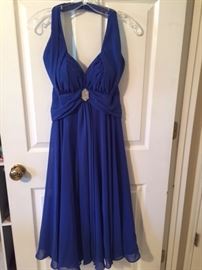 A lovely blue dress hanging on a door. This used to be mine, but I don't have the legs for it anymore. Confused? 