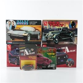 AMT Ertl "The A-Team" Van and Other Pop Culture Model Kits: A collection of five model car kits. This collection features two copies of an AMT Ertl kit for building a 1:25-scale model of the GMC Vendura van from the 1983 action series The A-Team, a 1:24-scale Monogram kit for the Daytona Spyder from Miami Vice and a 1:25-scale AMT Ertl Dick Tracy car kit. Also included are a Revell SnapTite The Rodent Ford Street Rod kit from the Night Crawler series and an Ertl 1:64-scale die-cast replica of the A-Team van.
