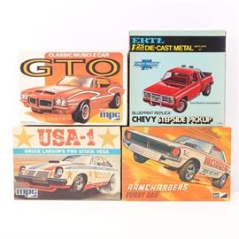 Vintage Model Car Kits featuring MPC: A grouping of vintage model car kits. This grouping offer four kits including three by mpc depicting a GTO, Bruce Larson’d Pro Stock Vega, and Ramchargers Funny Car. There is also a ERTL metal and plastic kit of a Chevy Stepside Pickup. All four kits are presented in original boxes and have not been used.