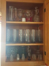16 of the blue glass tumblers on the center shelf