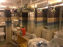 sinks, vanities and toilets in shower room. There are washer/dryer units in this room as well as a row of showers. All items are for sale - every, pipe, light, nut and bolt.