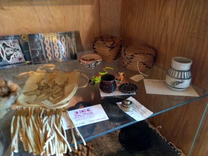 Assorted Native American crafts, including pottery, baskets, minature horsehair baskets and doeskin art