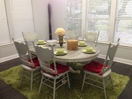 Six person dining room table with leaf (table can also be circular instead of oval). Azure blue paint with carved wooden detail. Staging furniture.