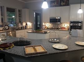 Kitchen items including bell jars, flatware, cookbooks and more.