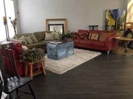 Living room furniture set including coffee table trunk, rug, two sofas, an armchair and numerous end tables and decor items. Staging furniture.
