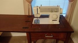 sewing machine in cabinet