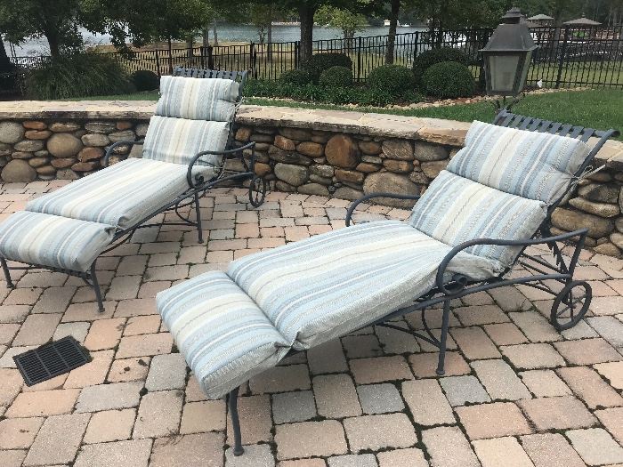 Pair of metal lounge chairs with cushions 