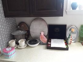 Specialty tea of the world, tea sets, tins, potholders, and other silver items.