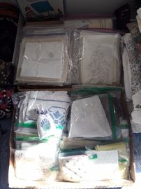 Various linens, including napkin sets, change purses, tablecloths and more.