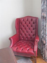 Deep red leather tufted wing chair