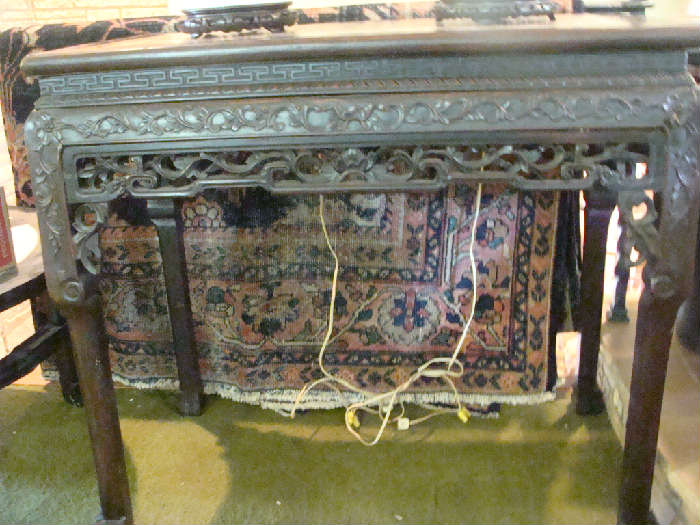 Extremely old, highly carved & beautiful antique oriental table from the 1800's behind can be seen an antique oriental rug approx. 9 by 11, same circa and in wonderful condition
