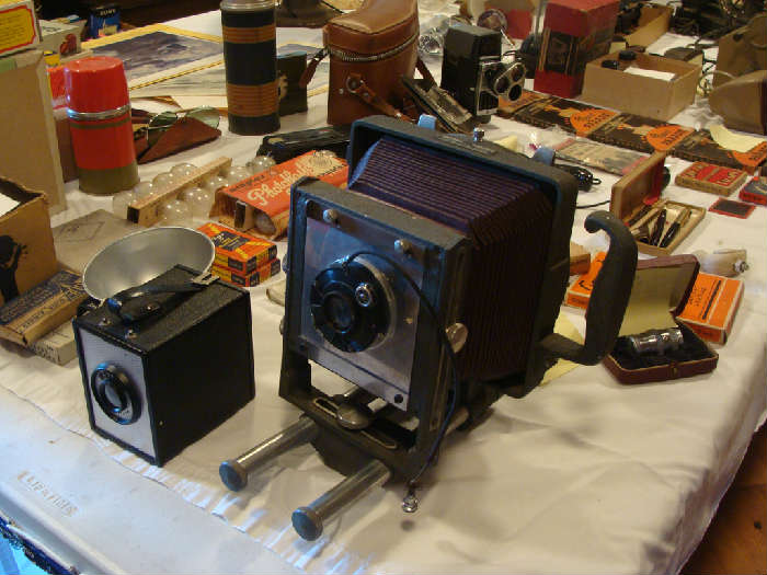 Greystone and Ansco Vintage Cameras also many vintage lenses, Castle WWII newsreels 8mm, editing machine, flashbulbs and other vintage photo items.