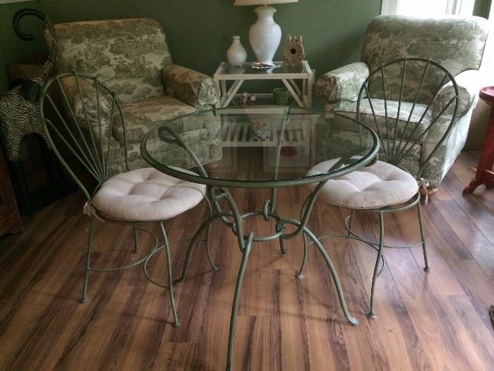 Wrought Iron green glass top table and four chairs.