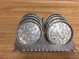 Set of 8 aluminum coasters with carrier.