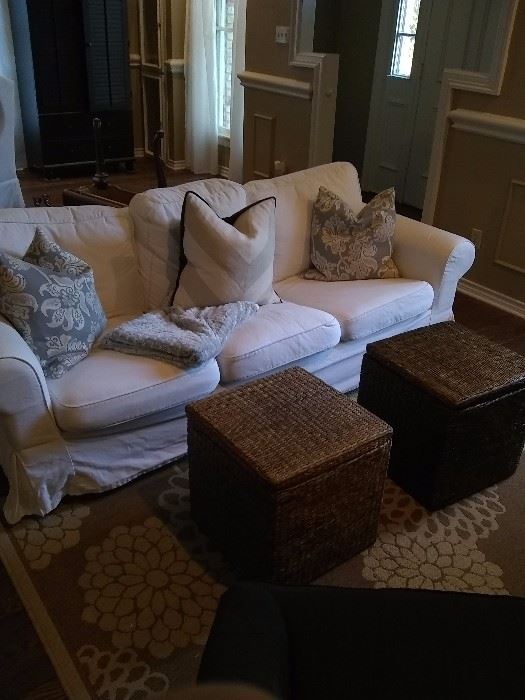 Small sofa, area rug, wicker baskets