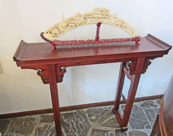 Asian motif table with carved (resin) decoration in the style of carved ivory pieces