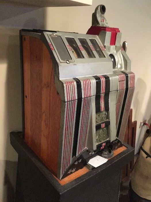 Vintage 1930s Mills nickel slot machine. Working condition with keys and stand.