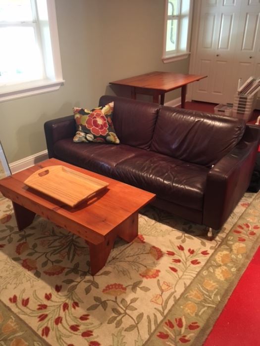 Leather couch, rug and coffee table.