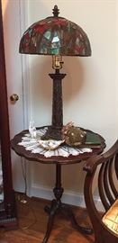 Round table with tiffany style lamp.