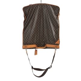 Louis Vuitton Garment Bag: A garment bag by Louis Vuitton. This garment bag showcases a signature brown monogrammed exterior trimmed with tan leather and mustard-colored contrast stitching. This item features multiple zippered compartments for storage and an adjustable shoulder strap. It is marked with brand labels.