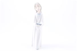 Lladro "Girl with Candle" #4868: A Lladro “Girl with Candle” porcelain figurine, #4868. The girl depicted is clothed in her white night gown and holding a candle in her hands. She is gazing wistfully to the side. The figurine is marked with the LLadro stamp and bellflower. The figure was released in 1974 and retired in 1992, the sculptor was Fulgencio Garcia.
