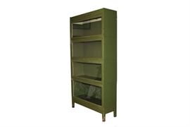 Vintage Painted Green Barrister Bookcase: A vintage barrister bookcase, painted green. It has four stacked cases, each with wooden body and glass paned front door, which lifts up and pushes back. It has a solid wood topper and is raised on a solid wooden base with tapered block feet. Each door has a small knob.