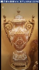 Large antique vase with cherubs on each side of the handle