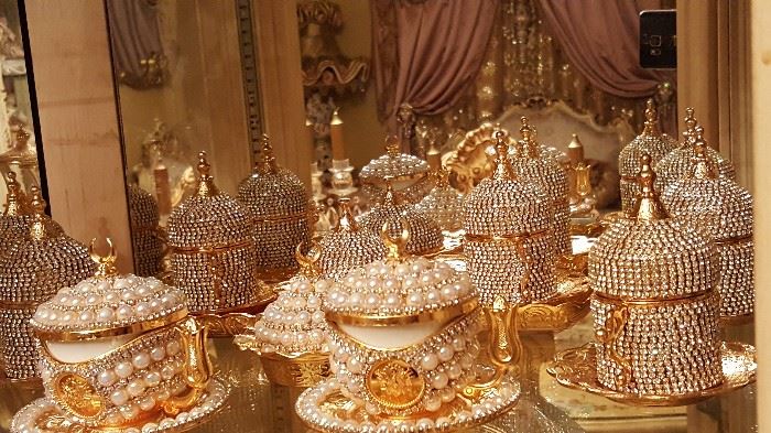 6 piece coffee cup sets with lid that is gold plated and covered with pearl and svorski Crystal. This comes with six cups creamer and sugar, 6 plates and a tray that goes with the set