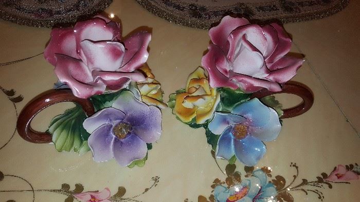 Two small Capodimonte floral pieces that hold candles