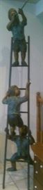 Bronze statue kids climbing up the ladder