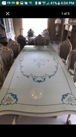 Italian dining room table with artwork and eight chairs