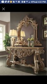 Hallway table with large carved mirror and granite table