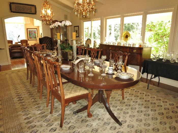 Very Large Oval Mahogany Pedestal Dining Table with Ten Chippendale-Style Dining Chairs on a Palace-Size Persian-Style Rug.