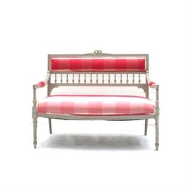 Vintage French Provincial Style Settee: A vintage French Provincial style settee. This settee features a carved arch to the crest rail above a cushion back supported by turned spindles that are flanked by stiles that attach to the rectangular upholstered seat flanked by sloped arms that rise above tapered and fluted legs terminating on arrow feet.
