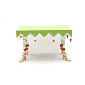 Patience Brewster Krinkles High Heel Table: A Patience Brewster high heel table. This hand-painted table has a green rectangle top and zigzag apron edged in white. The table stands on four high heel, gold leaf shoes with red bows and green and white striped stockings. Gold stars and red hearts hang from hidden hooks attached to the inside of the table.