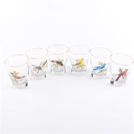 Hand-Painted Birds Rocks Glasses: A set of hand-painted bird-themed rocks glasses. Offered are six clear rocks glasses with a gilt rim and a hand-painted American songbird to each glass. The pieces are not marked.