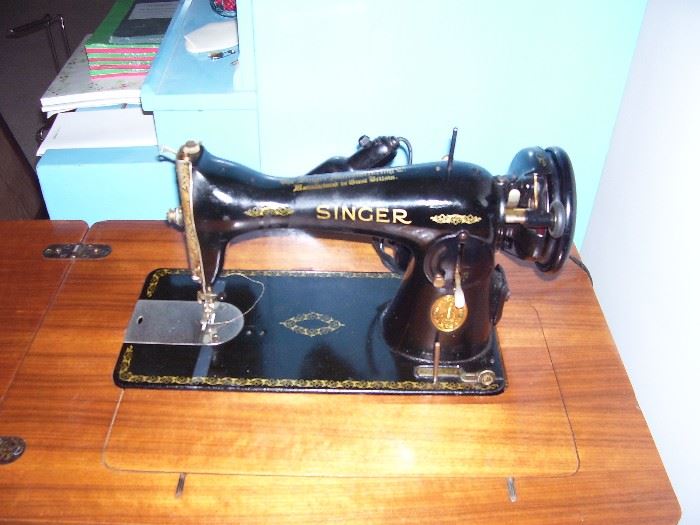 Singer Sewing machine in cabinet with chair