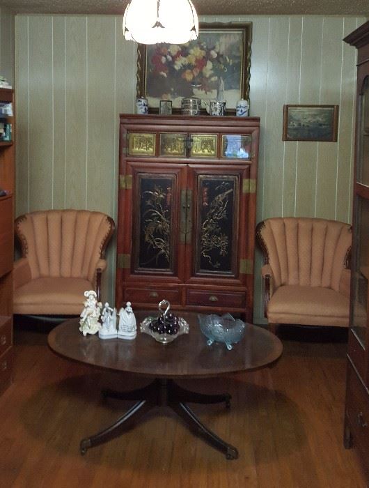 Beautiful Asian style cabinet, tufted armchairs and oval coffee table
