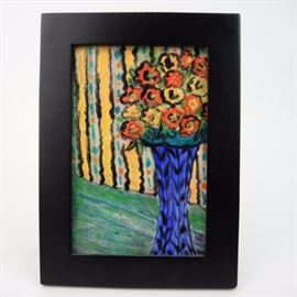 Original Signed Enamel on Copper Painting by Mary Kinsey: An original enameled copper painting art plate by Mary Kinsey, featuring an arrangement of yellow and orange flowers in a tall blue vase with black leaf detailing. The vase rests on a blue-green table against a yellow and floral striped background wall. The piece is signed “MK” in the lower right corner and framed in black wood.