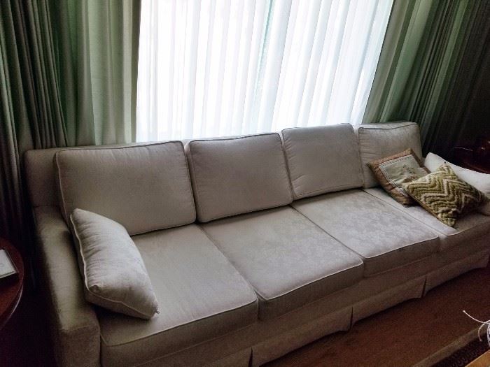 Sofa upholstered in patterned white fabric with four back and four seat cushions. Manufacturer unknown. Asking $69.00