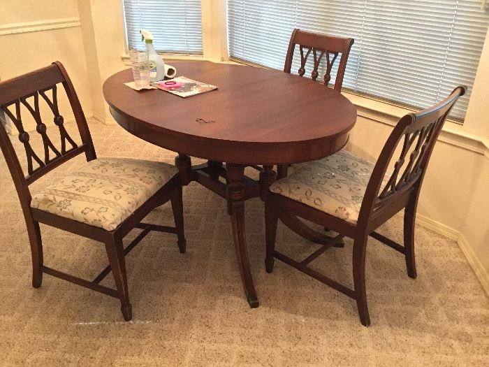A nice dining table with (4) upholstered chairs