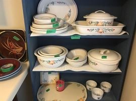 Bottom shelf has 6 placemats to set and miscellaneous items.