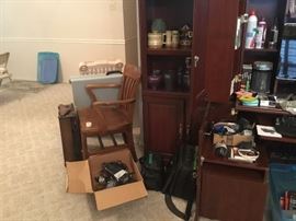 More items in shelves of office furniture, cords of all kinds along with great old oak side chair